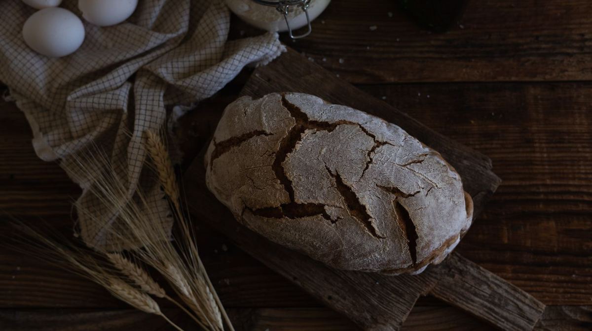 A homemade loaf of bread on a wooden board